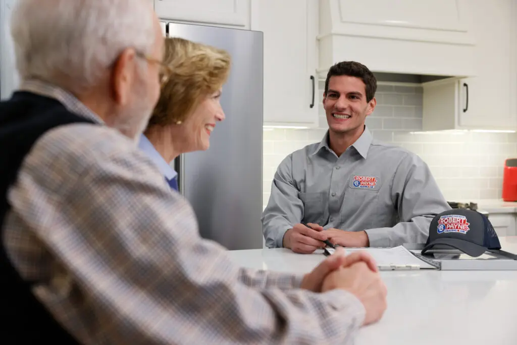 Robert B. Payne technician speaking with a Fredericksburg homeowner